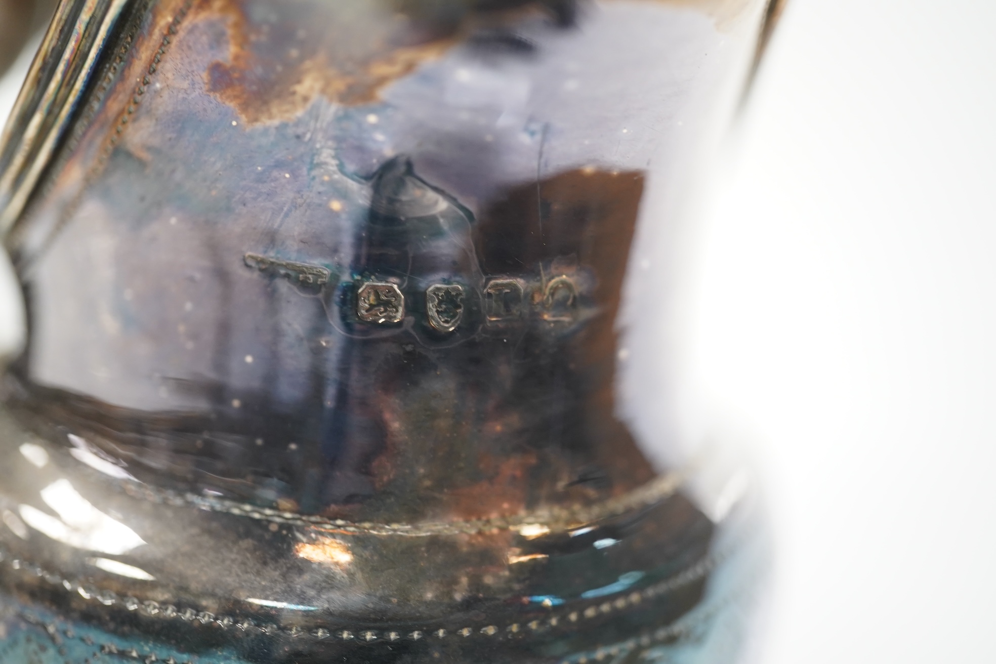 A William IV silver christening mug, London 1834, 10cm, a George III silver cream jug, London, 1799 and three small silver trophy cups. Condition - poor to fair